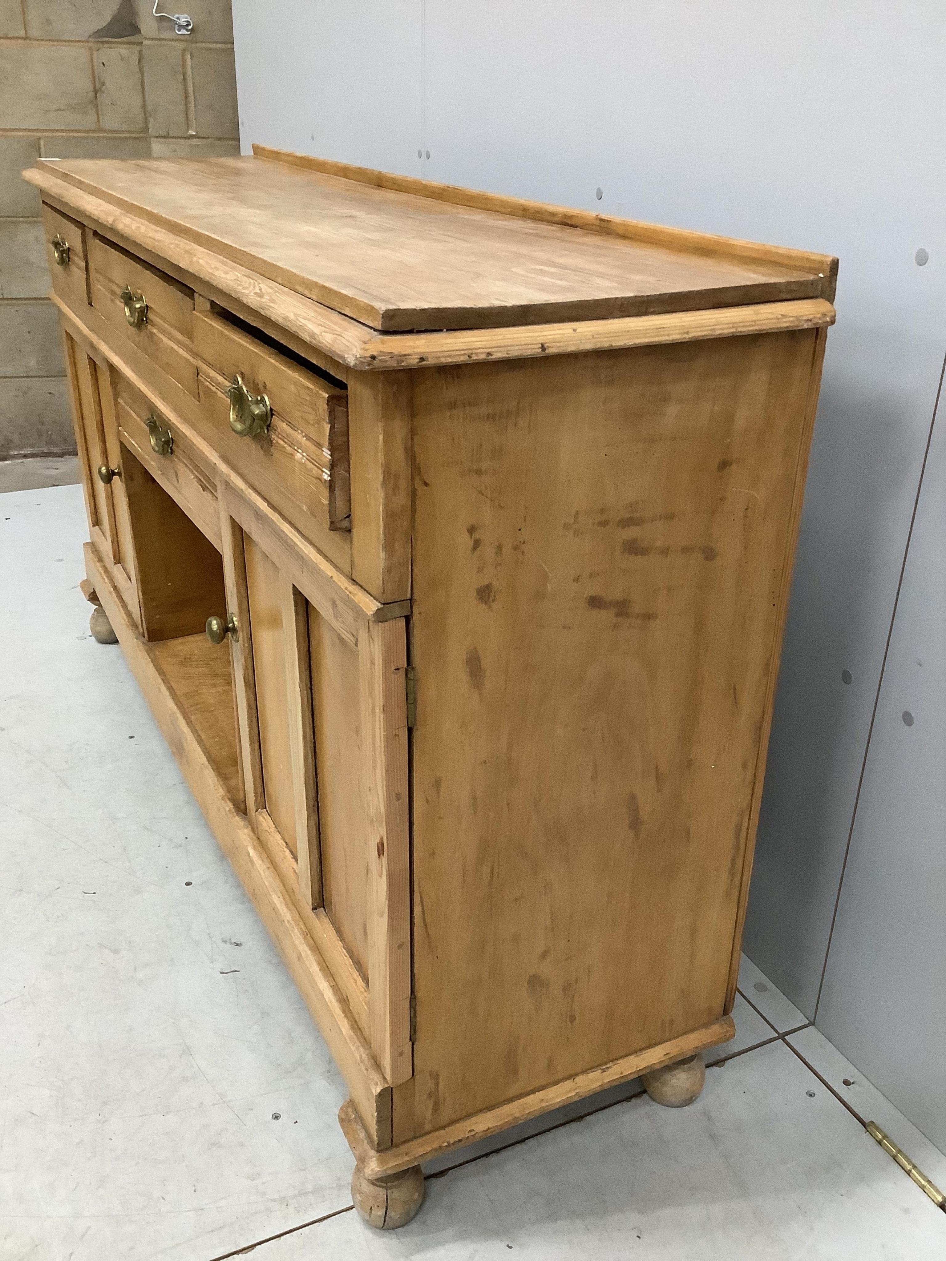 A late Victorian pine low dresser, width 154cm, depth 42cm, height 90cm. Condition - fair